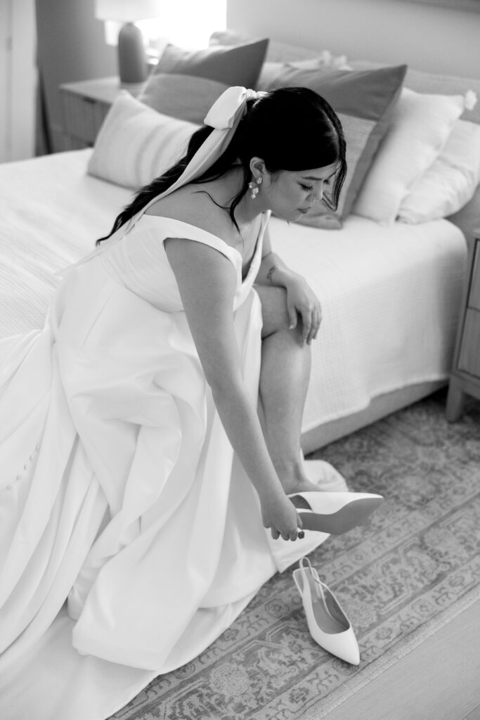 Bride puts on wedding shoes at the Gathering Space 