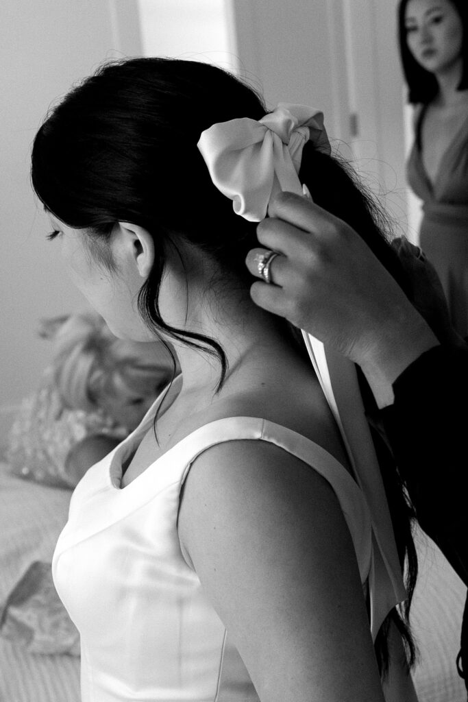 bride puts on finishing touches before her intimate wedding 