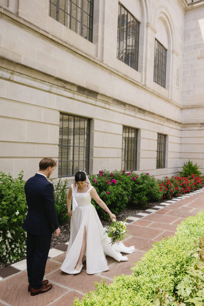 Bride and Groom take bridal portraits outside the nebraska capitol building 