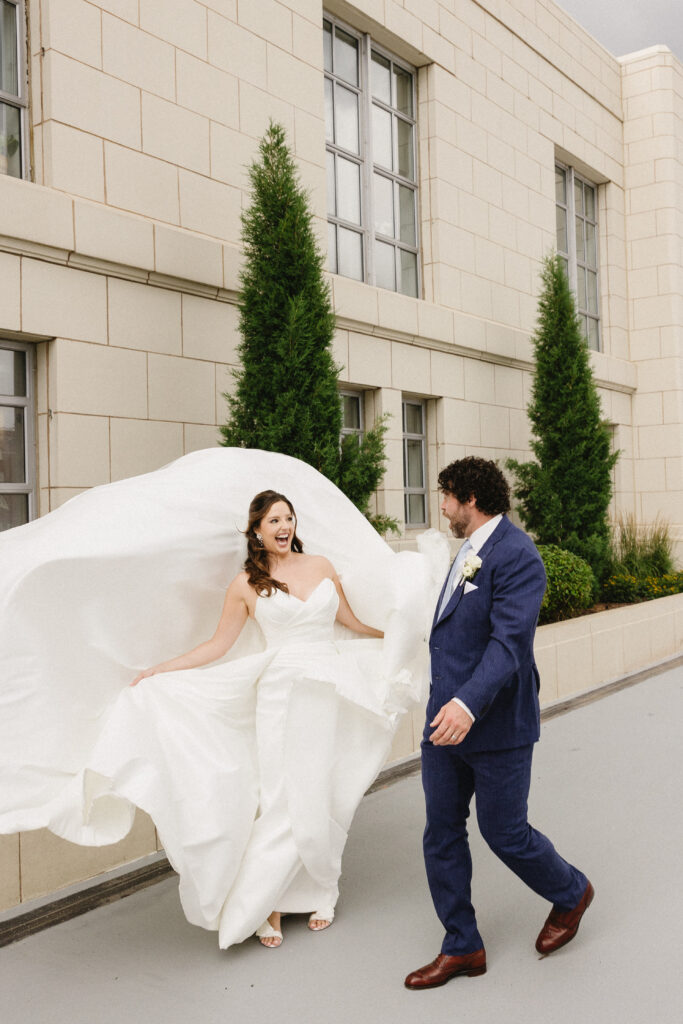 Bride and Groom taking wedding day portraits in the wind