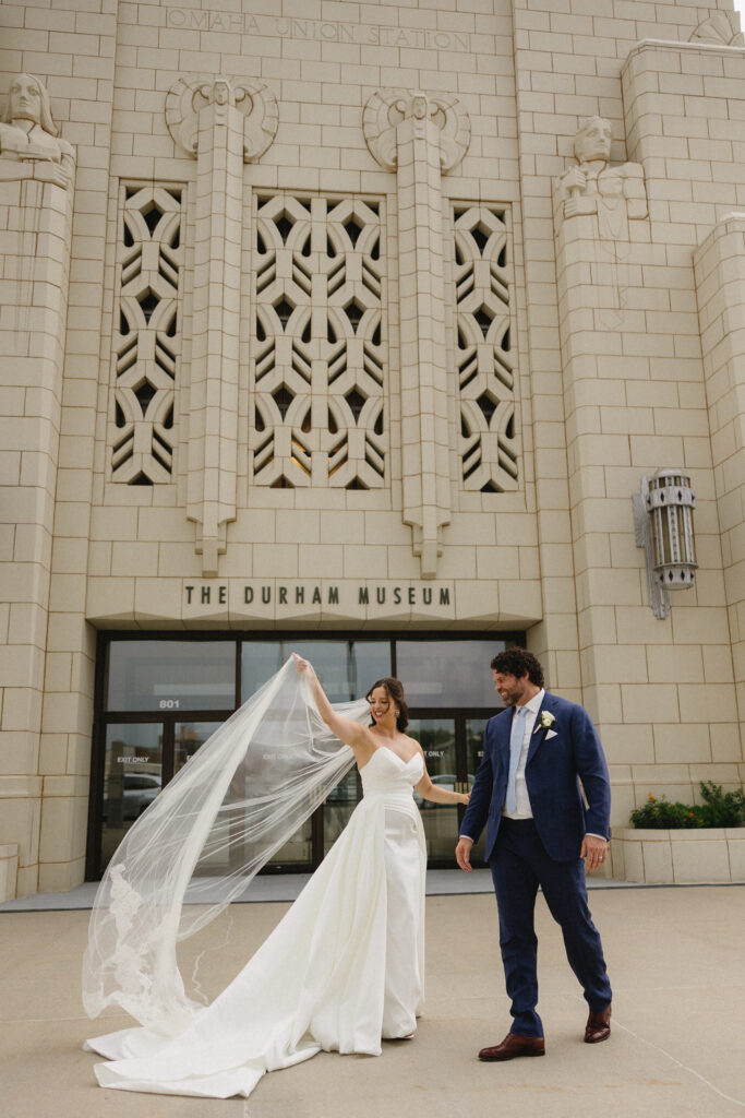 bride and groom outside the Durham Museum on their wedding day 