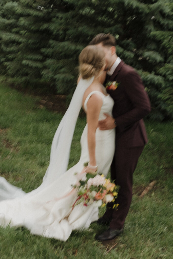 bride and groom kiss as they take wedding day portraits at Heartland country Barn 