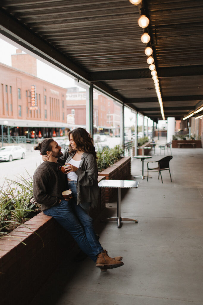 outdoor engagement pictures at a coffee shop  in downtown lincoln nebraska