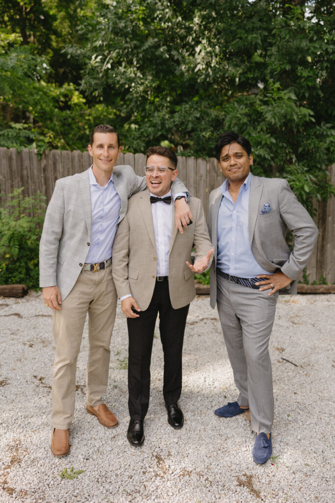 groom and his close friends before an outdoor wedding ceremony 