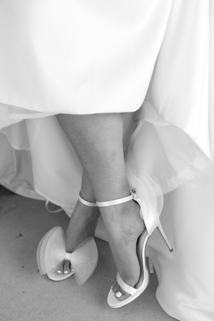 Black and white wedding detail photo of bride's heels