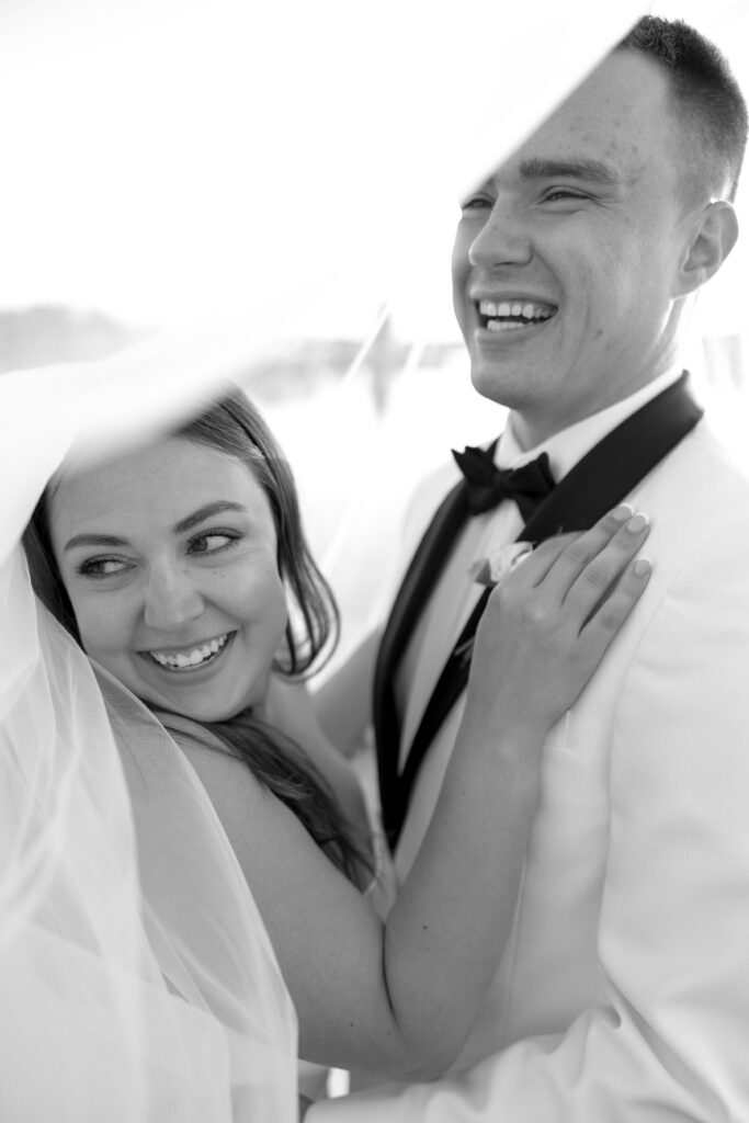 Bride and Groom take wedding photos at the lake after their A View at West Shores Wedding 