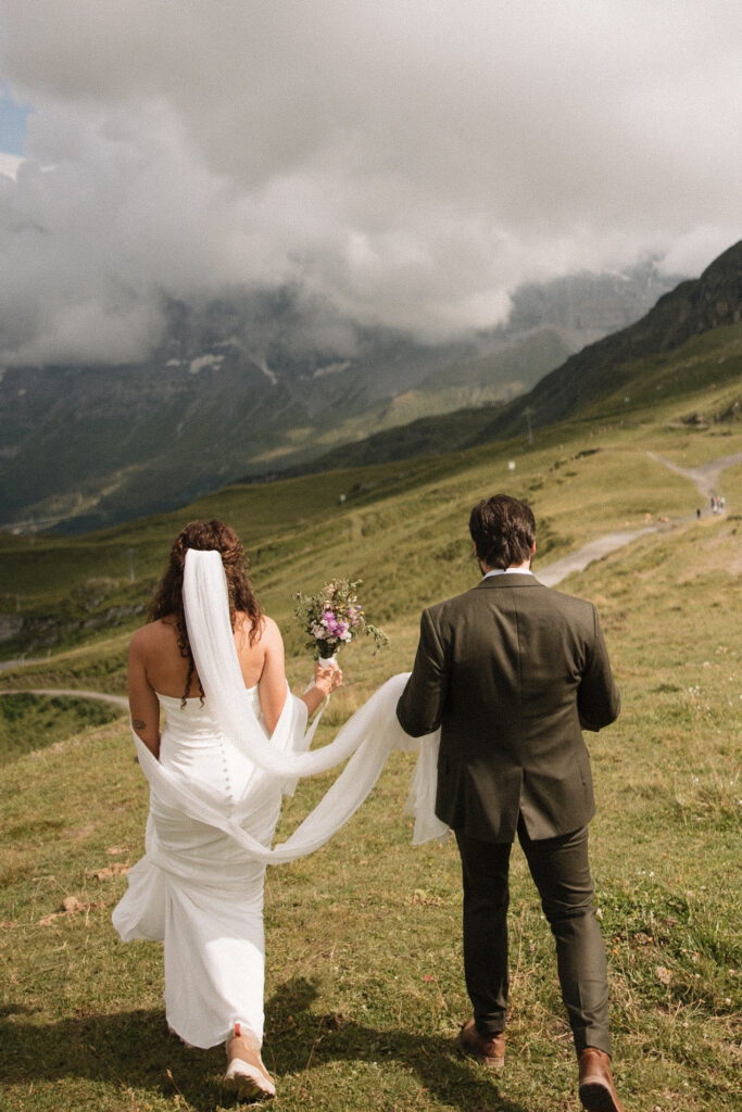 Bride and Groom walk in the Swiss Alps near Grindelwald Switzerland after their elopement 