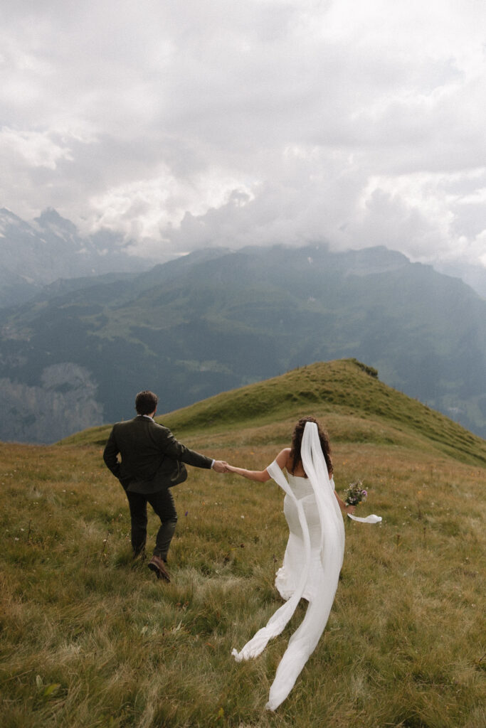Bride and groom take wedding photos in the swiss alps