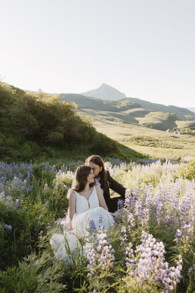 Carter and Faith sit in a field of purple wild flowers