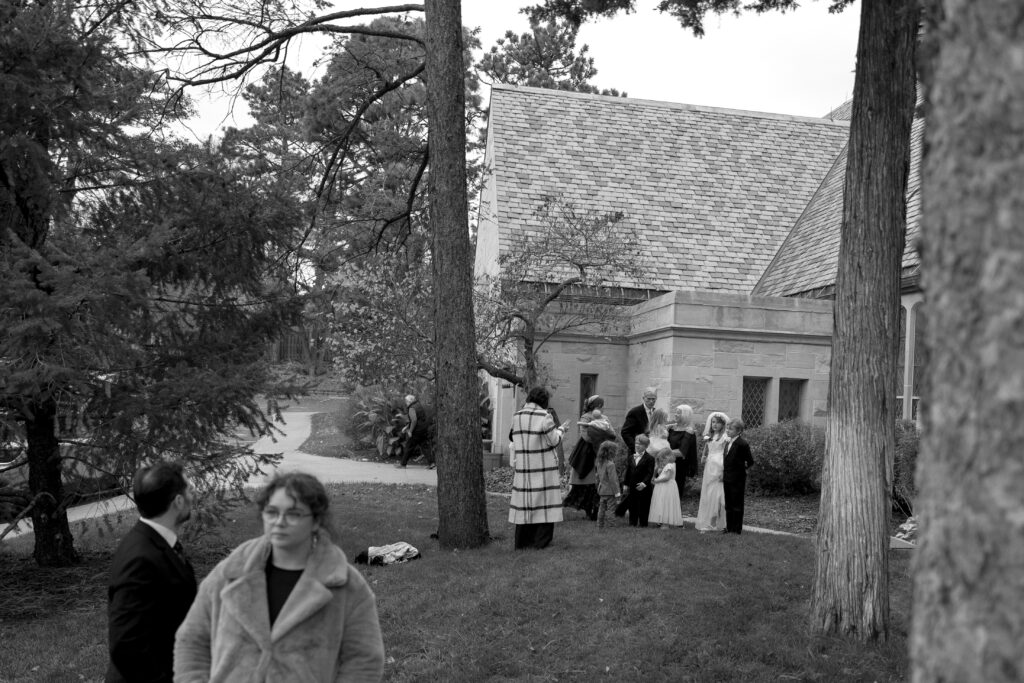 family outside of church after wedding