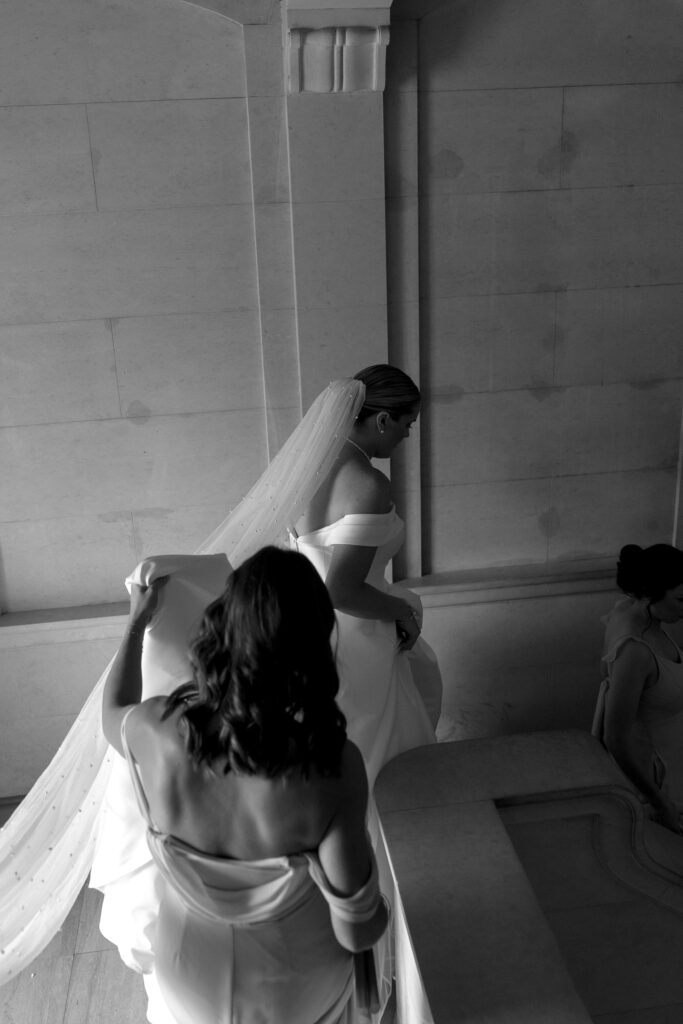 bride walks down the marble staircase at the church 