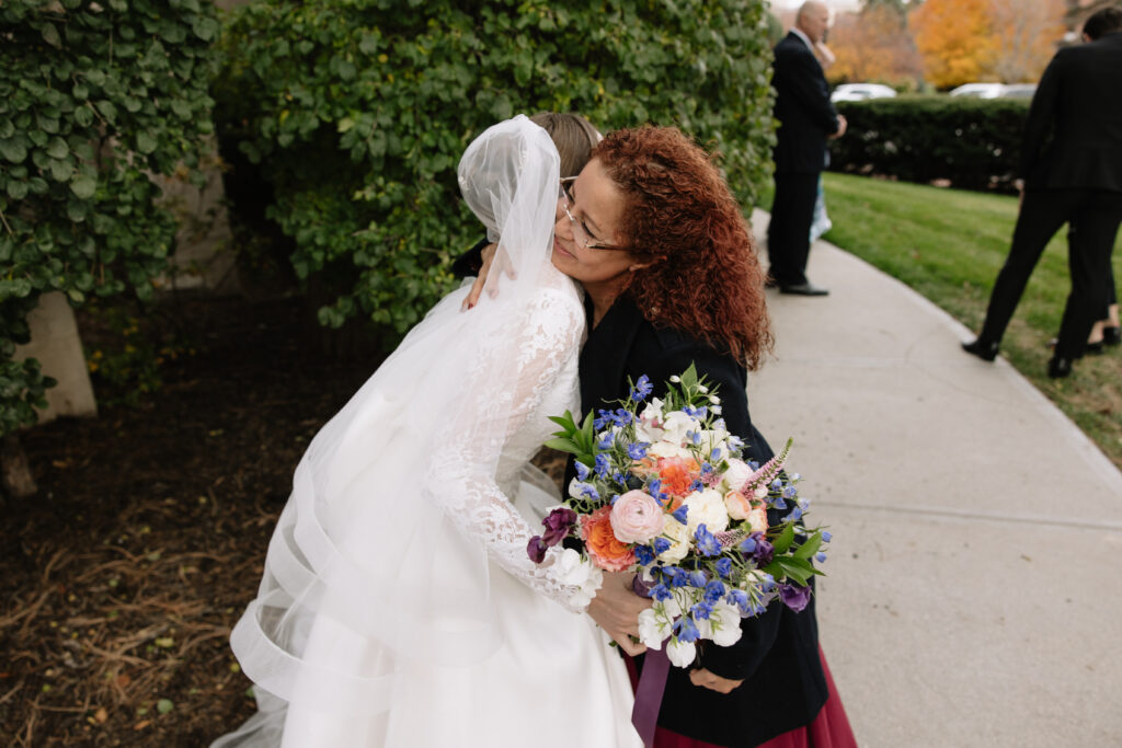 bride hugs guest after wedding