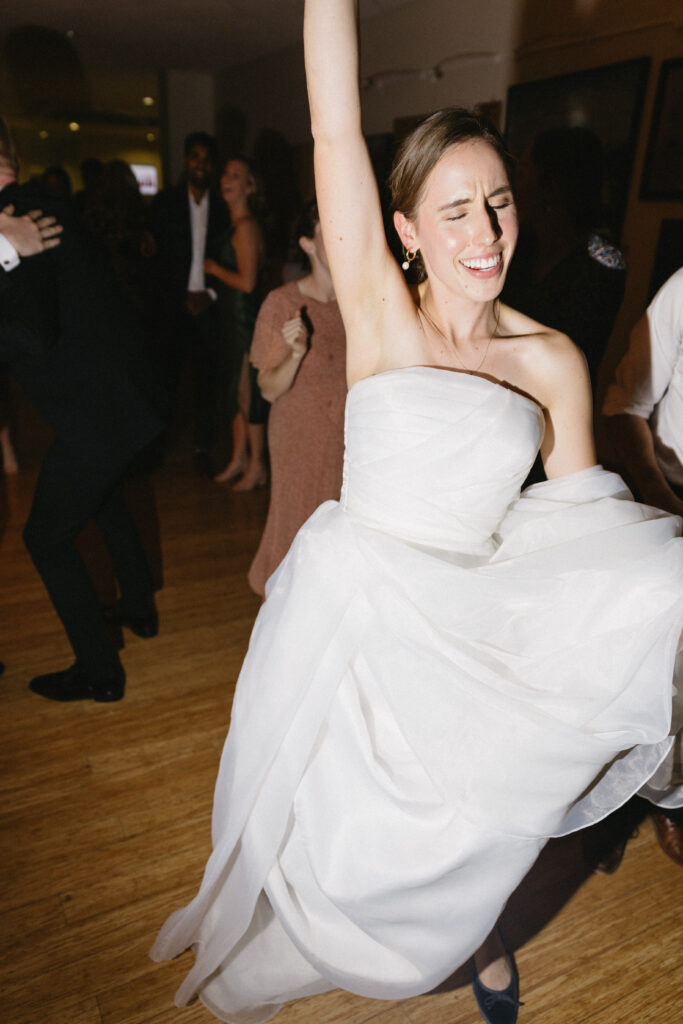 Bride dances as her photographer captures a candid moment 