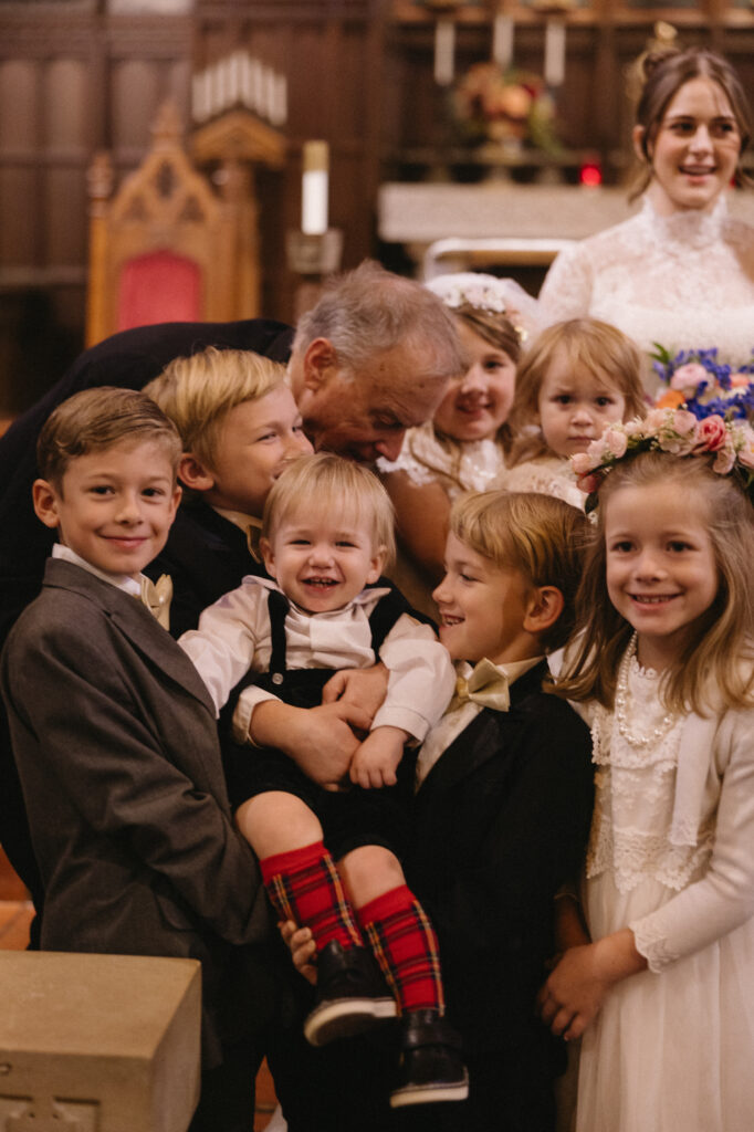 children laugh as they get ready for family portraits 