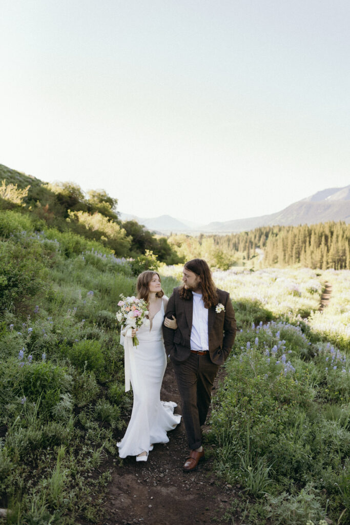 Bride and Groom walk together in the field at Mountain Wedding Garden in Crested Butte, Colorado