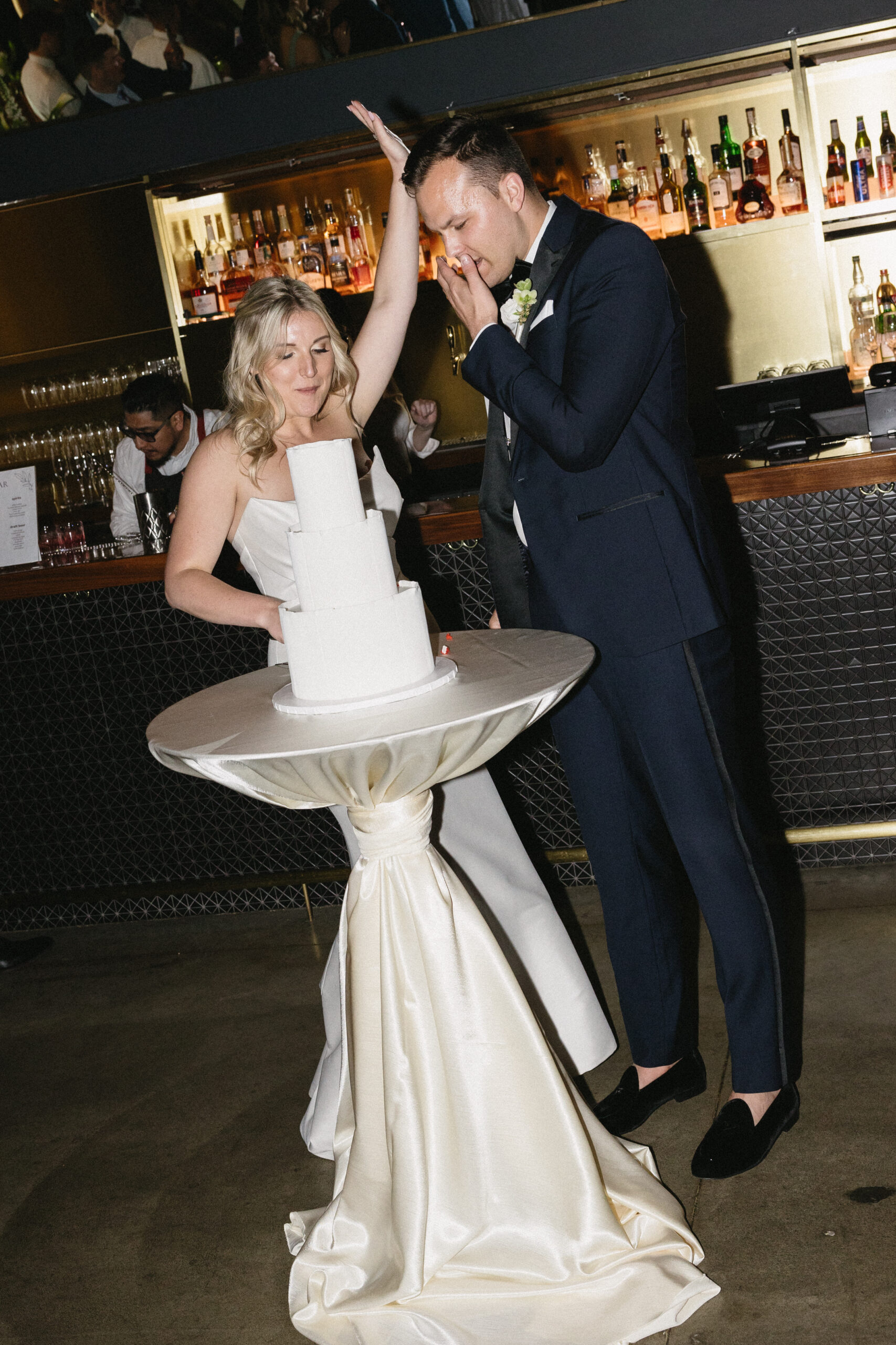 Bride and groom cut the cake at wedding reception