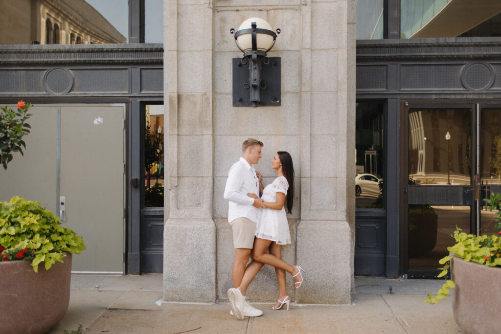 Tyler and Kenzie take engagement photos outside the courthouse in downtown omaha 