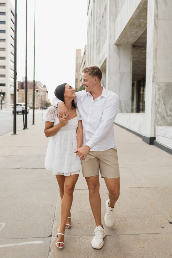 Tyler and Kenzie walk down the street in downtown omaha 