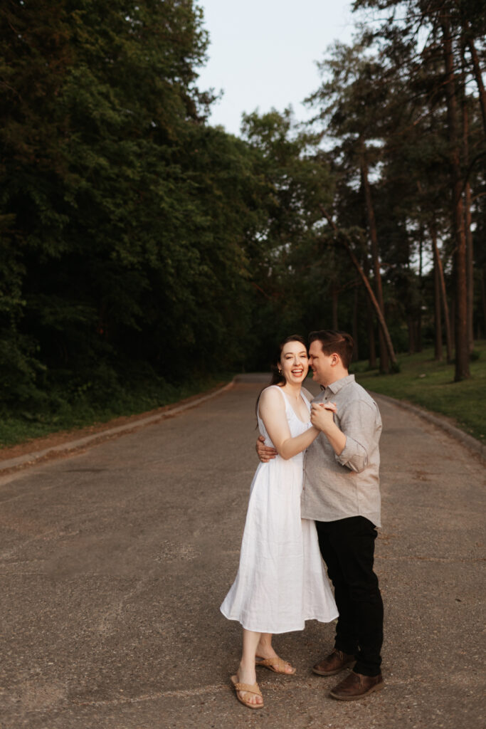 engagement photos at elmwood park in omaha nebraska on an open road