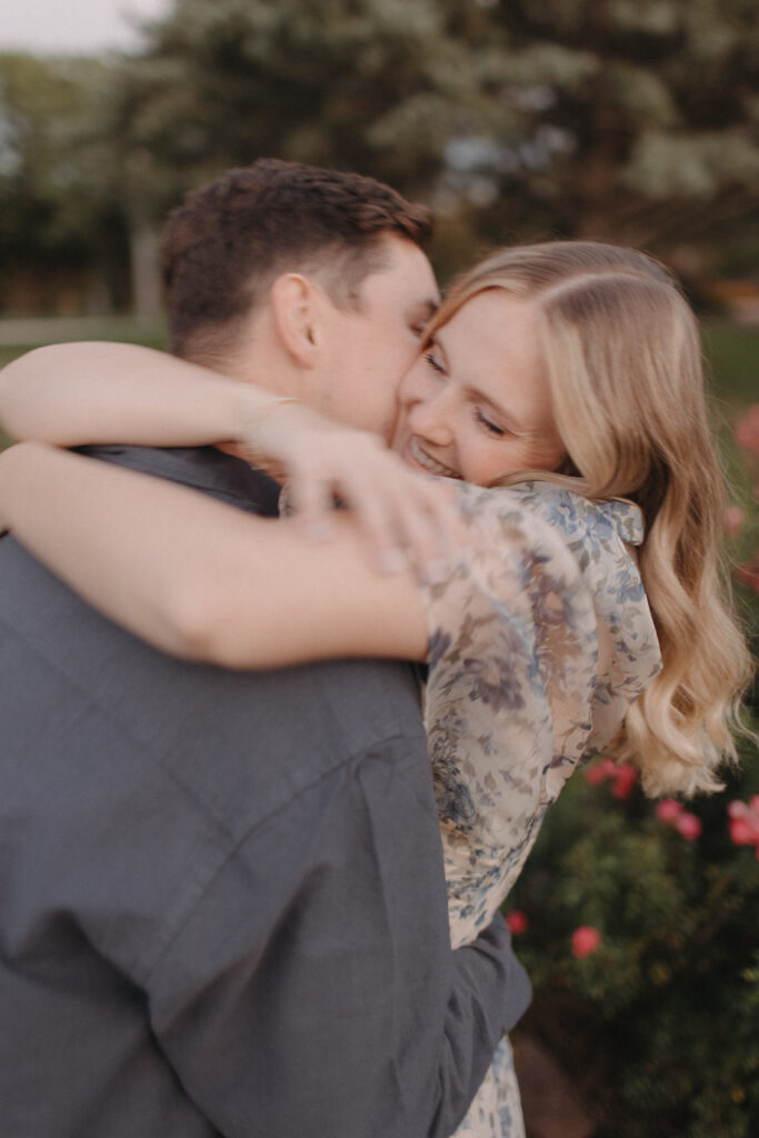 couple hugs in memorial park rose garden