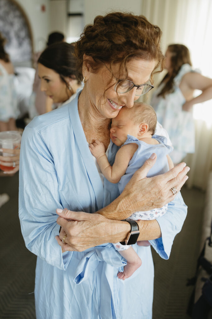 grandmother and newborn get ready for the wedding 