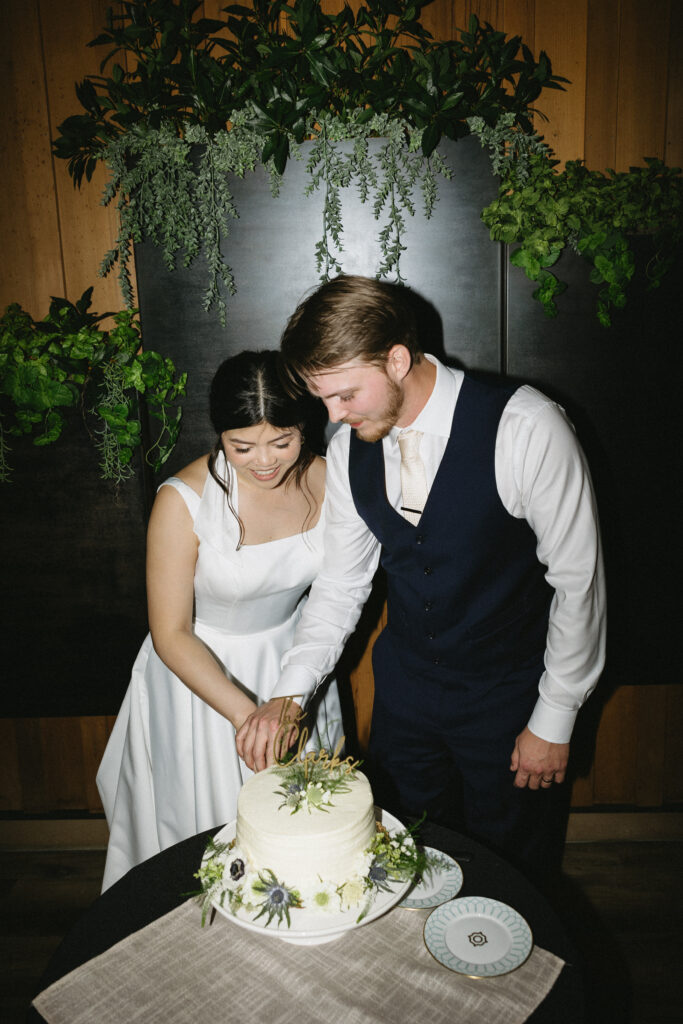 bride and groom cut the cake at their intimate reception 