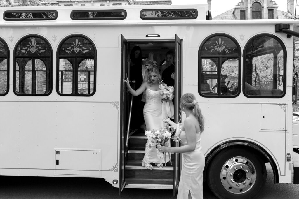 bride exits the trolley to get married at the church 