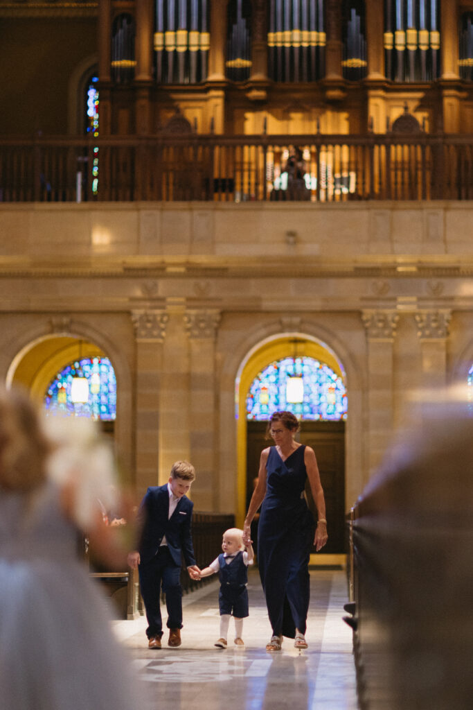 ring bearer walks down aisle 